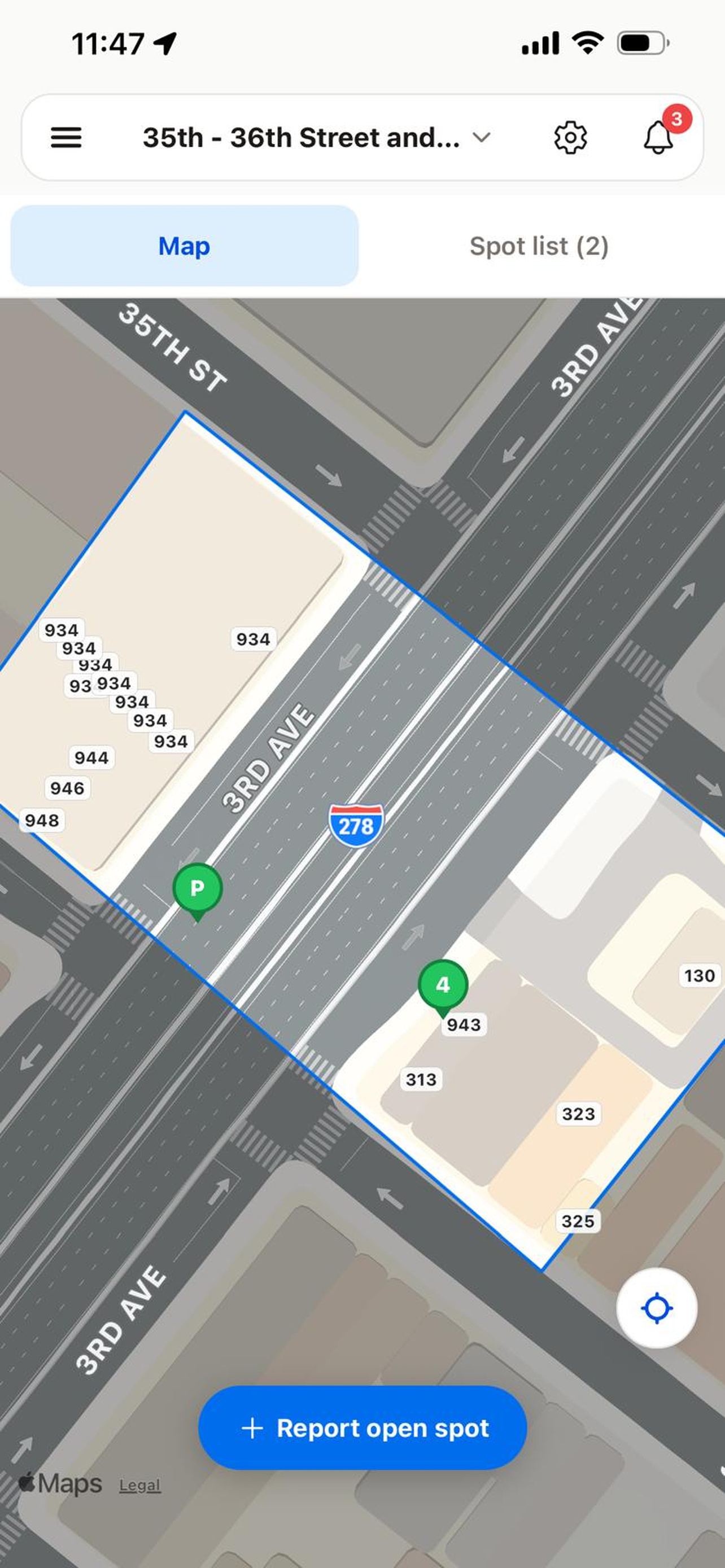 Spotlert’s street map with a blue parking-group boundary and two green parking pins, including a report of four spaces.